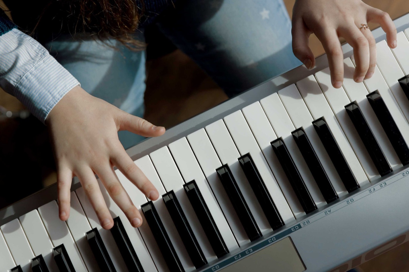 A student's hands on a piano keyboard