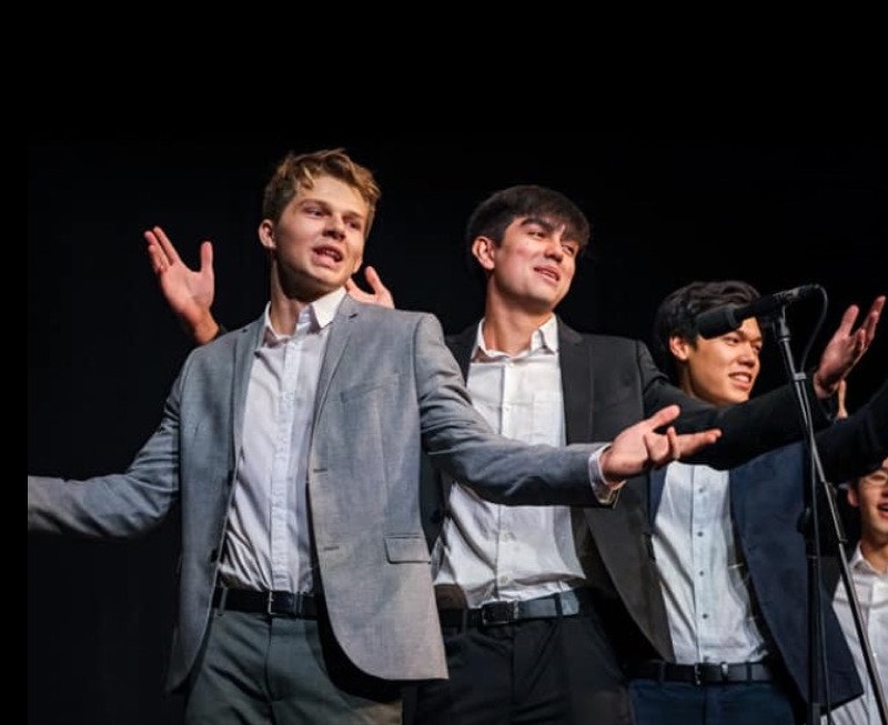 Three young vocalists performing on stage